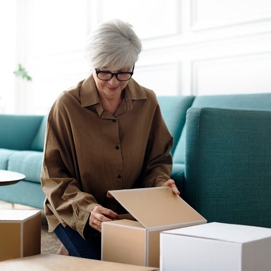 Woman,Unpacking,Brown,Boxes,In,The,Living,Room