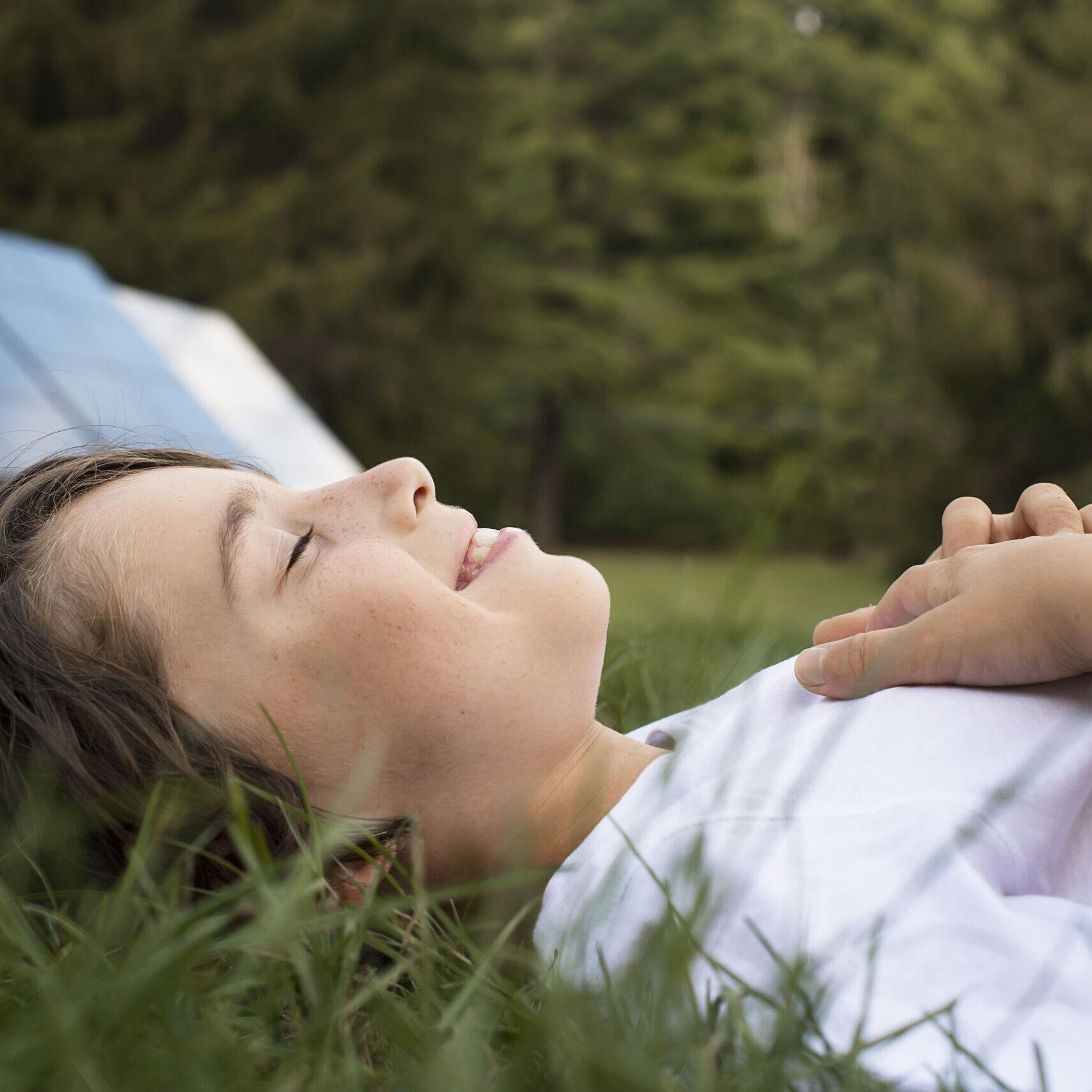 A,Boy,Lying,In,The,Grass,,Beside,A,Solar,Panel.